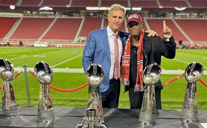 Former Menlo School three-sport star John Paye (left) and his old teammate Toi Cook pose at Levi's Stadium with the San Francisco 49er Super Bowl trophies.